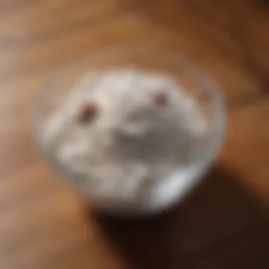 White diatomaceous earth powder in a bowl on wooden surface